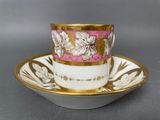 a close up of a cup and saucer on a saucer