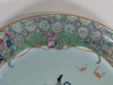 a plate with a bird on it sitting on a table