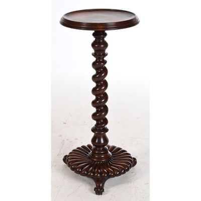 une table en bois avec un plateau rond et un piètement en bois