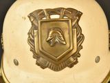a gold helmet with a shield on top of it