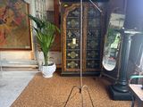 a lamp that is on a tripod stand in a room