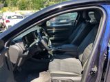the interior of a car with the door open and the driver ' s seat down