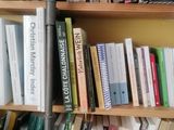 a bookshelf with many books on it in a room
