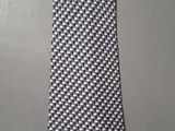 black and white checkered necktie on a gray background