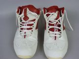 pair of white and red sneakers with white laces on them
