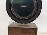 an old radio sitting on top of a wooden stand