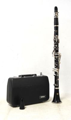 a black and silver clarinet next to a black case