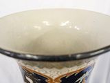 a vase with a blue and white design on it