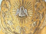 a gold cloth with a picture of two doves on it
