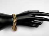 a close up of a mannequin hand with a gold chain bracelet