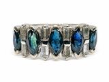 a close up of a ring with blue and green stones