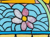 a stained glass window with a flower in it
