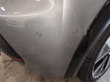 the front bumper of a car with a denting dent on it
