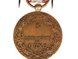 a medal with a ribbon around it on a white background