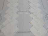 a lot of napkins on a table with a white table cloth