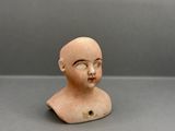 an image of a small clay head of a child