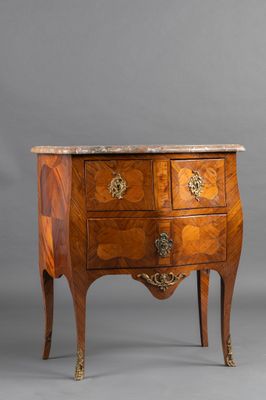 an antique chest of drawers with marble top