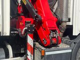 a red crane that is sitting on the back of a truck