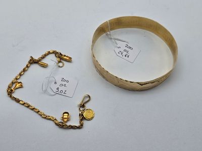 a gold bracelet and a gold bracelet with a tag on it