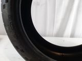 a close up of a tire on a table with a white background