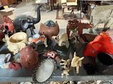 many different types of figurines displayed on a table