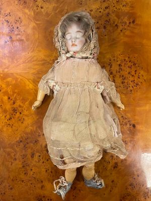 a doll that is laying down on a wooden floor