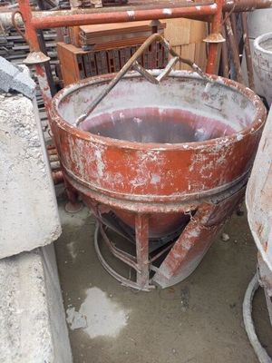 a cement mixer in the middle of a pile of cement