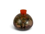 a brown vase with a red top on a white surface