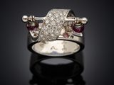 an image of a diamond and ruby ring on a black surface