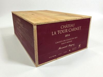a wooden box with a label on it that says chateau la tour carnet