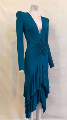 the dress is blue and has long sleeves and a v - neck