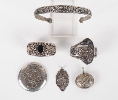 an assortment of silver jewelry including a cuff, ring, and other items