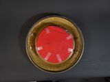 a picture of a red and gold porthole on the side of a boat