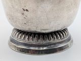 a silver bowl that is sitting on top of a table