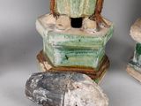 three ceramic figurines of a man and a fish on a table