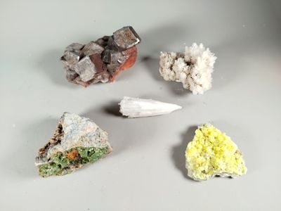 five different types of rocks and crystals on a table
