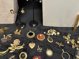 a lot of gold jewelry on a black table