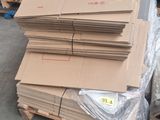 a pile of cardboard sitting on a pallet in a warehouse
