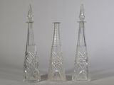 three glass vases sitting next to each other on a table