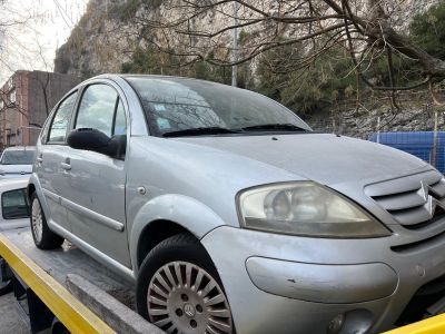 a silver car on the back of a flatbed tow truck