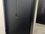 an image of a black metal cabinet in a bathroom