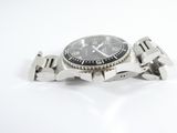a watch that is sitting on a white surface