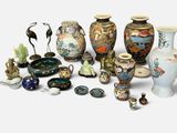 many different vases and figurines sitting on a white surface