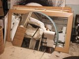 a mirror that is sitting on the floor in front of a mirror
