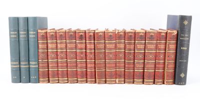 several old books are lined up on a shelf on a white surface