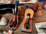 many different types of smoking pipes on a table