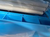 a plastic container with a roll of toilet paper in it