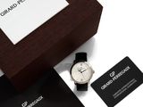 a black and white watch and business card on a table