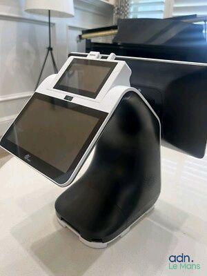 a tablet computer sitting on a stand in a room