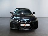 the front view of a black bmw car in a showroom
